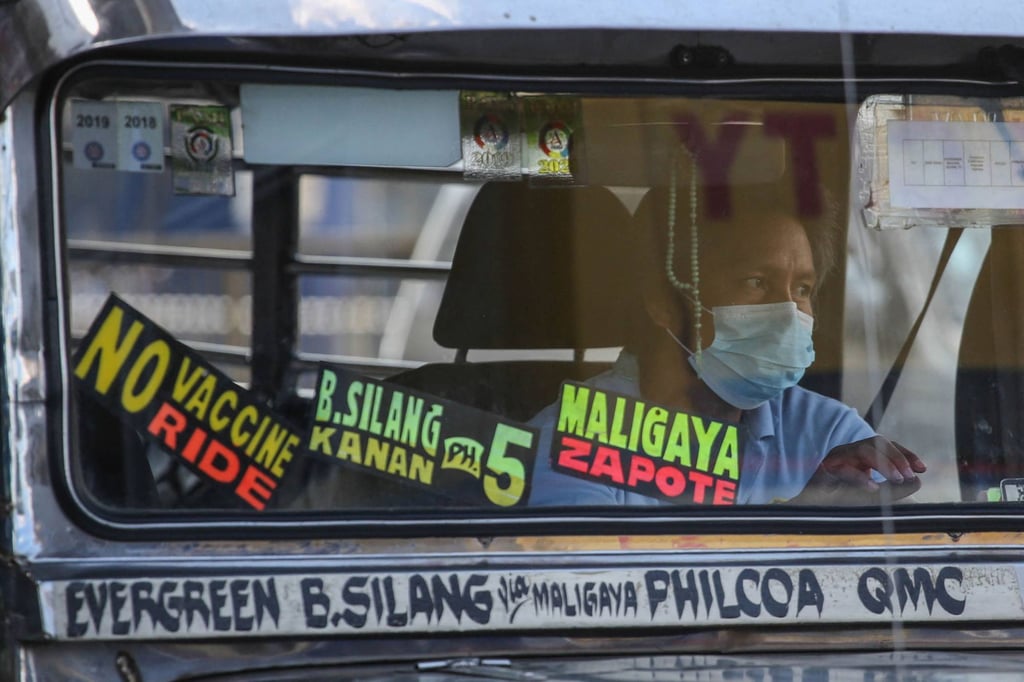 A ‘No Vaccine No Ride’ sign on a passenger jeep in suburban Manila on Monday. Photo: AFP A ‘No Vaccine No Ride’ sign on a passenger jeep in suburban Manila on Monday. Photo: AFP