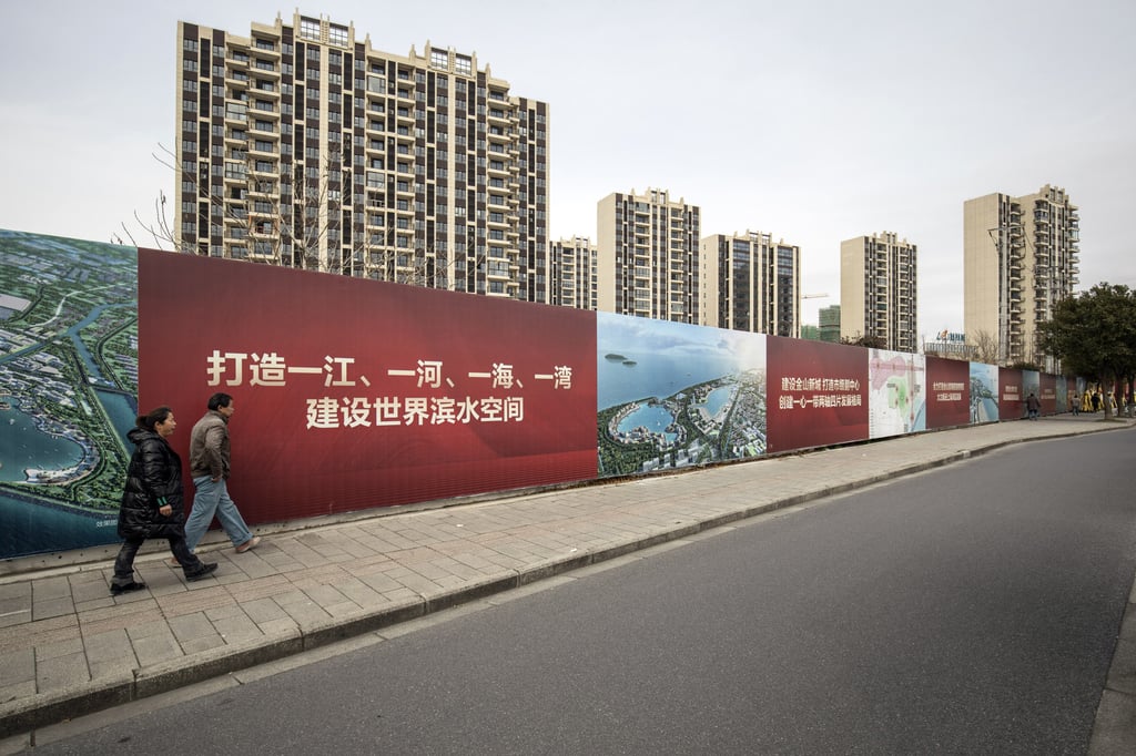 People walk past apartment buildings at the Phoenix City residential project, developed by Country Garden Holdings, in Shanghai, China, on January 17. While not yet a systemic threat to global markets, the liquidity crisis in China’s property market is spreading within China. Bloomberg