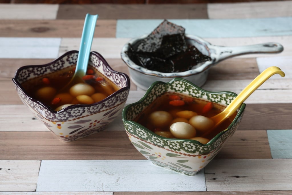 Sesame brittle tong yuen with ginger broth. In the old days, cooks would have had to grind glutinous rice by hand to make the festive dessert. Photo: SCMP/Jonathan Wong Sesame brittle tong yuen with ginger broth. In the old days, cooks would have had to grind glutinous rice by hand to make the festive dessert. Photo: SCMP/Jonathan Wong