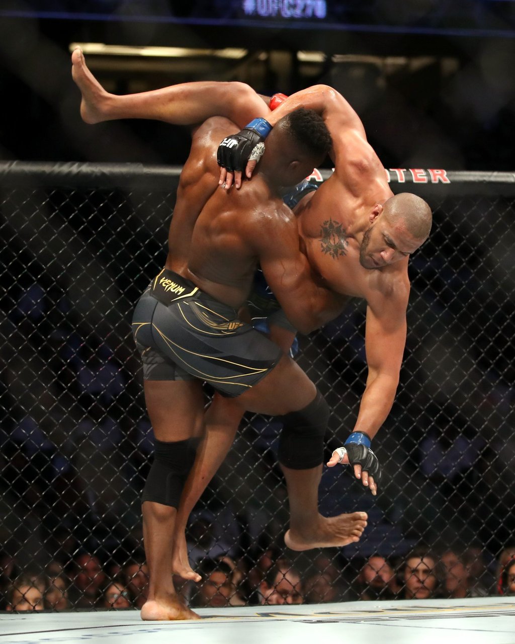 Francis Ngannou of Cameroon (left) wrestles Ciryl Gane of France in their heavyweight title fight at UFC 270. Photo: Katelyn Mulcahy/Getty Images/AFP