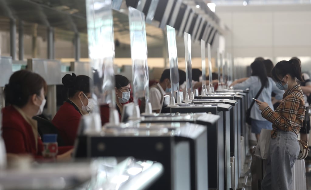 Cathay Pacific staff at Hong Kong International Airport. The airline flew 717,059 passengers last year, compared with 4.6 million in 2020. Photo: Xiaomei Chen