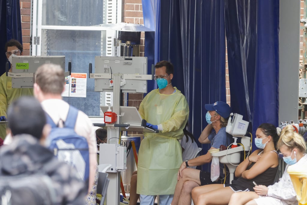 People queue at the main entrance of a hospital in Sydney. Photo: Jenny Evans/Getty Images via NZME People queue at the main entrance of a hospital in Sydney. Photo: Jenny Evans/Getty Images via NZME