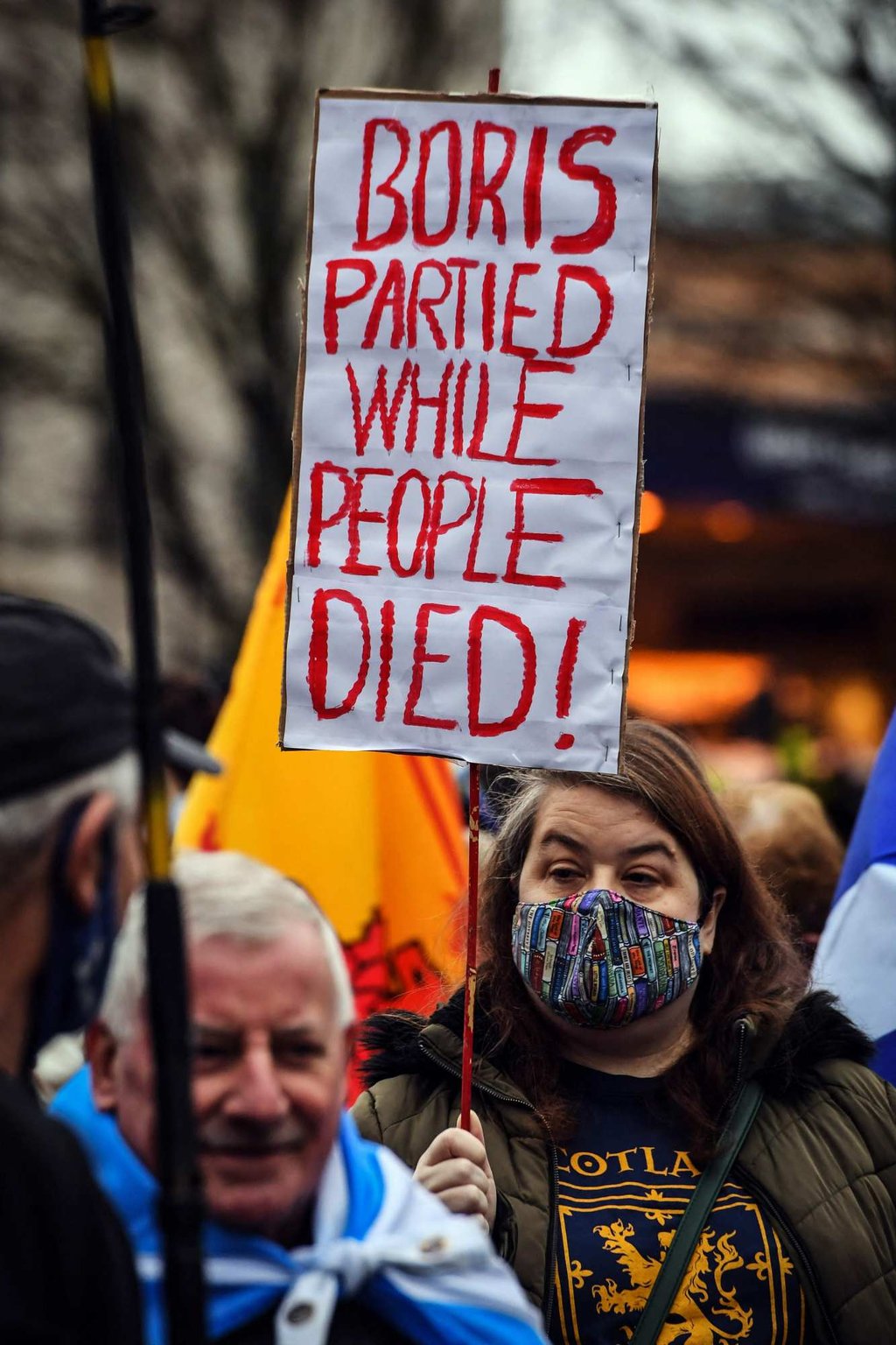 A protester holds up a placard during a March against Boris Johnson in Glasgow on Saturday. Photo: AFP