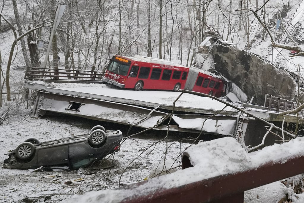 A bus and a car that were on a bridge when it collapsed on Friday in the US. Rescuers formed a human chain to help multiple people out of the bus. Photo: AP