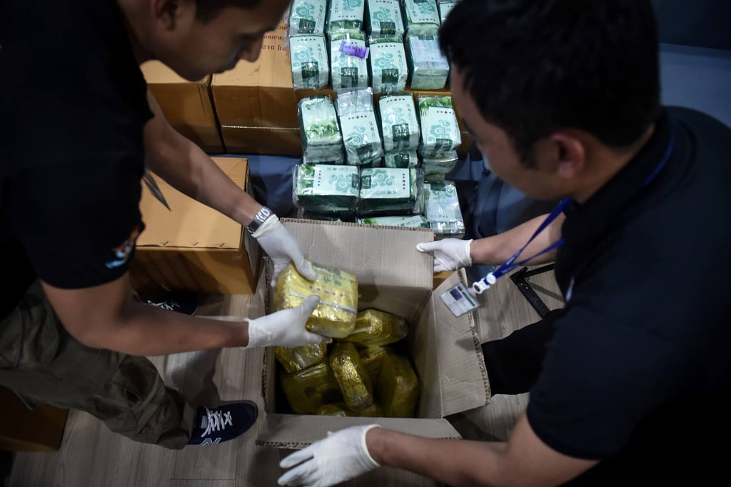 Narcotics police sort through packages of drugs. Photo: AFP Narcotics police sort through packages of drugs. Photo: AFP