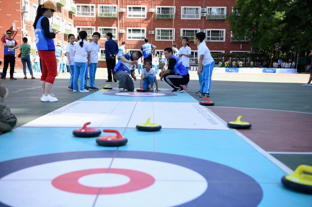 Beijing has requested that schools embrace educational activities around winter sports like curling, as seen here at Shijia primary school. Photo: IOC