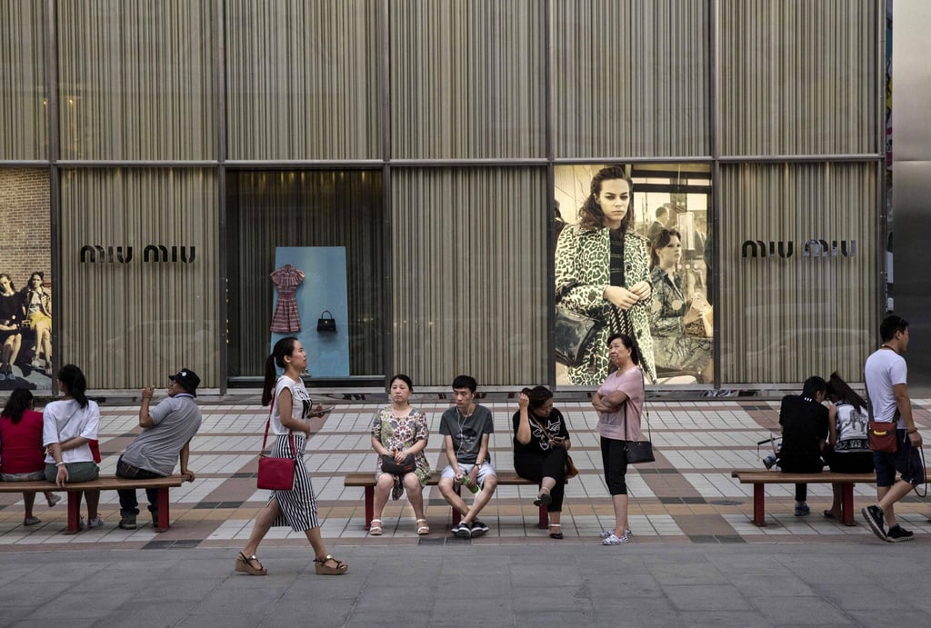 Chinese shoppers outside a Miu Miu store in Beijing, China. A report in China revealed older shoppers are far less likely than younger shoppers to be swayed by environmental issues when it comes to purchasing. Photo: Getty Images