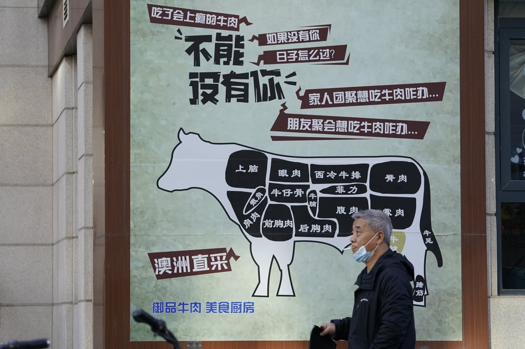 A man walks past an advert promoting imported beef from Australia in Beijing in November 2020. China stirred controversy with claims it had detected the coronavirus on packages of imported frozen food. Photo: AP