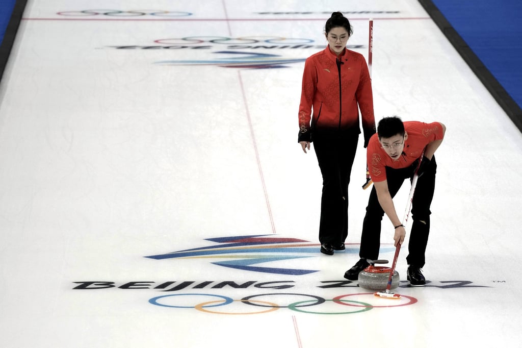 Fan Suyuan and Ling Zhi compete during their mixed doubles curling match against Switzerland, at the 2022 Winter Olympics. Photo: AP