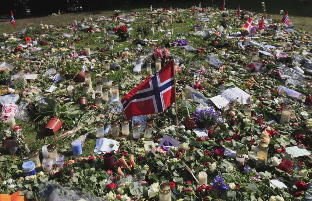 A Norwegian flag sits among flowers and tributes laid outside the Oslo Cathedral in Oslo in July 2011, in memory of the victims of a bomb attack and shooting spree that left 77 dead. Photo: AP