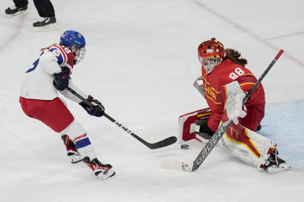 Czech Republic’s Michaela Pejzlova (18) scores a goal against China goalkeeper Tiya Chen (88) during a preliminary round of women’s ice hockey. Photo: AP