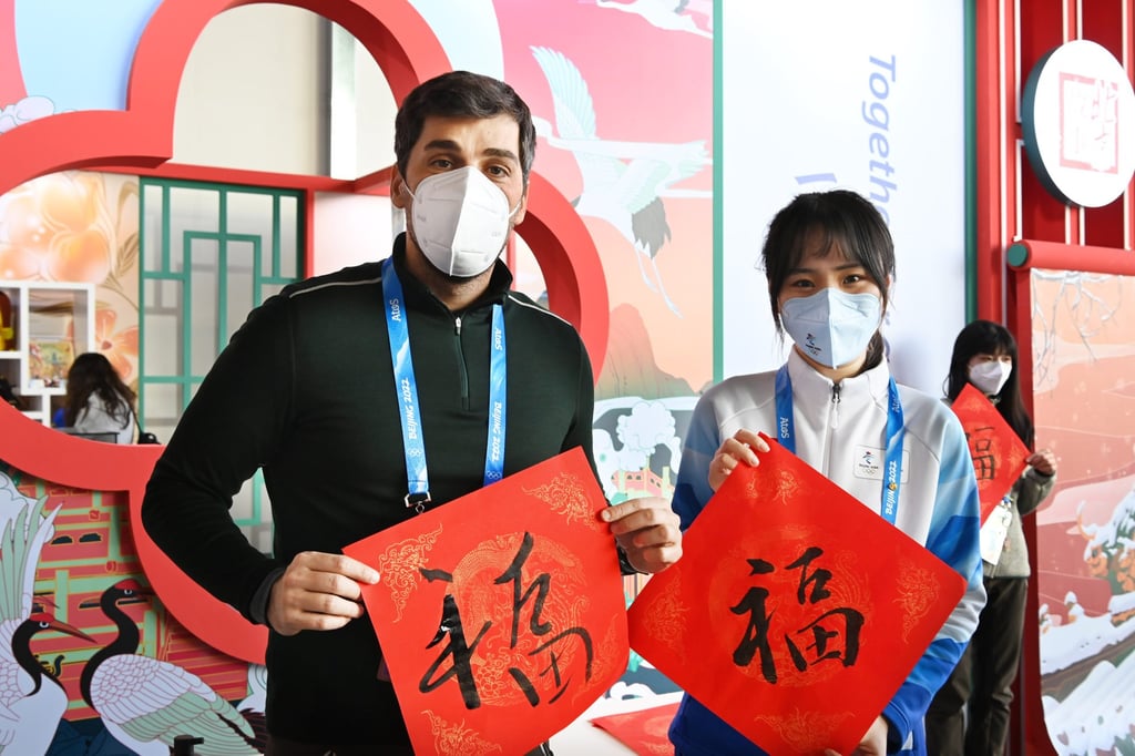 People show their calligraphy work of the Chinese character “Fu”, meaning fortune and luck in English. Photo: Xinhua