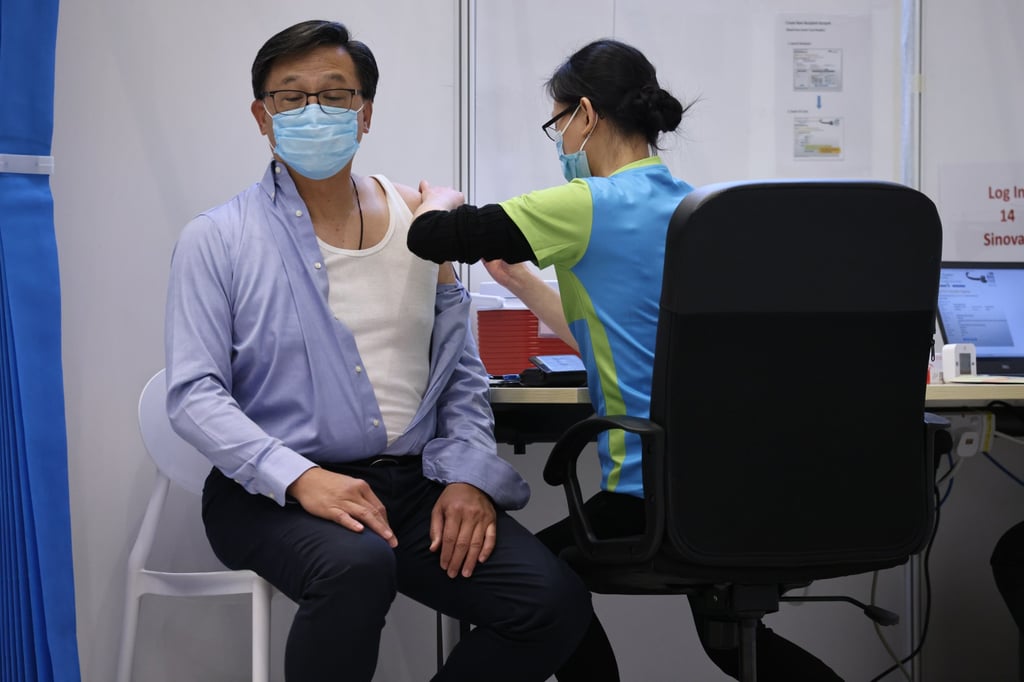 Lawmaker Junius Ho receives his second vaccination dose on March 22 last year. A day after Ho suggested advocates of the “live with Covid” approach might contravene the national security law, the government issued a press statement saying a discussion of Hong Kong’s coronavirus policy is not illegal. Photo: K. Y. Cheng