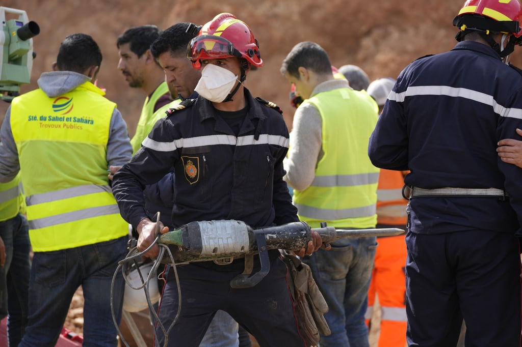 A civil defence worker attempts to rescue a boy who fell into a hole near Chefchaouen, Morocco on February 4. Photo: AP