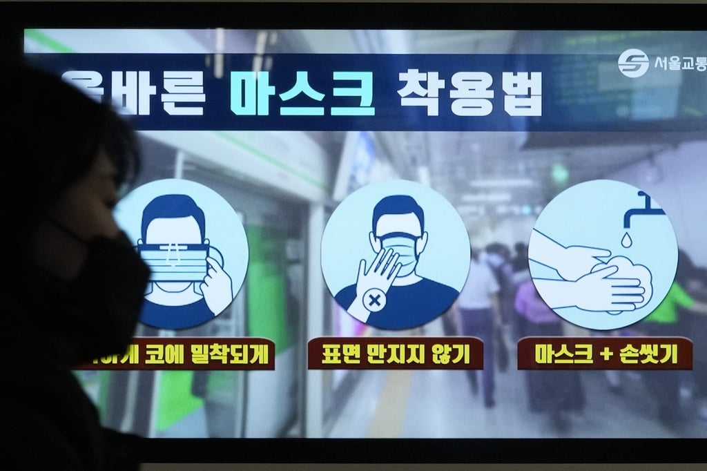 A woman walks past a screen showing precautions against the coronavirus at a subway station in Seoul. Photo: AP A woman walks past a screen showing precautions against the coronavirus at a subway station in Seoul. Photo: AP
