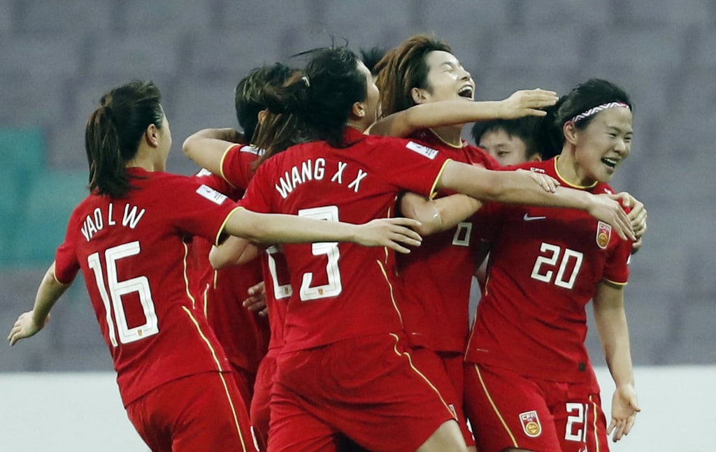 China’s Xiao Yuyi (no 20) celebrates with teammates after scoring their third and winning goal in stoppage time. Photo: Reuter