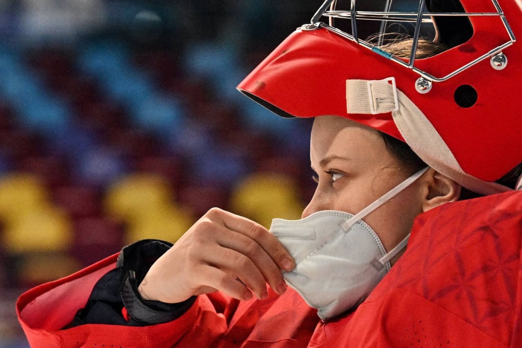 Russian Olympic Committee’s goaltender Mariia Sorokina checks her face mask during the match at the Beijing 2022 Winter Olympics. Photo: AFP