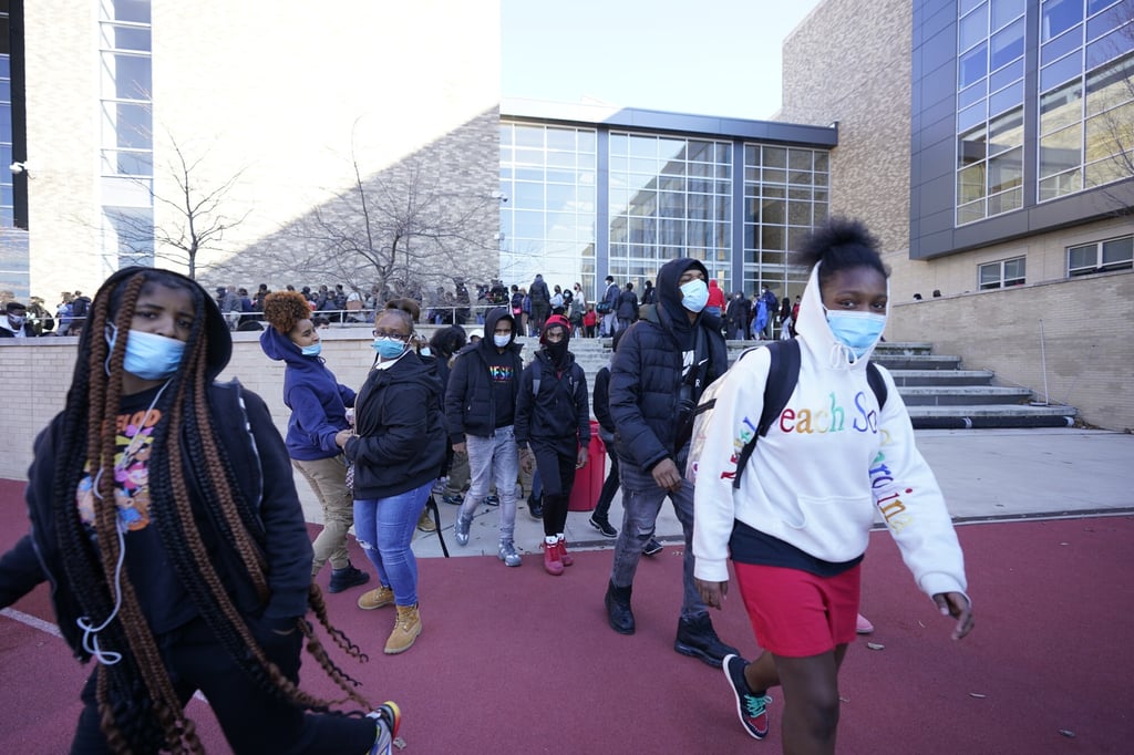 People leave Dunbar High School in Washington on Tuesday following an apparent bomb threat. Photo: AP