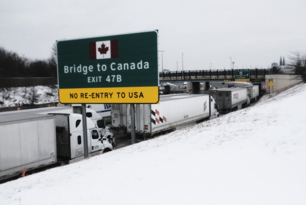 Hundreds of trucks and truck drivers attempting to cross Ambassador Bridge from Detroit, Michigan, to Windsor, Canada are stuck on the US side on Tuesday after the bridge was closed by Canadian protesters over vaccine mandates. Photo: Bloomberg Hundreds of trucks and truck drivers attempting to cross Ambassador Bridge from Detroit, Michigan, to Windsor, Canada are stuck on the US side on Tuesday after the bridge was closed by Canadian protesters over vaccine mandates. Photo: Bloomberg
