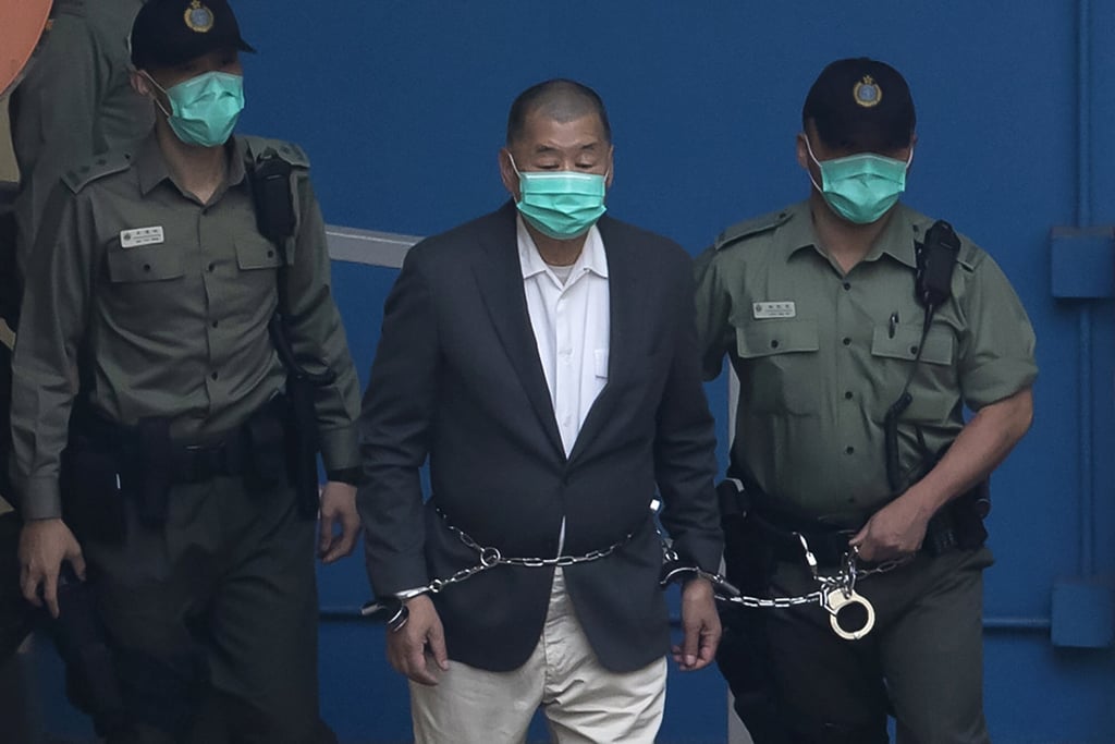 Jimmy Lai, who founded Apple Daily, is escorted by Correctional Services officers to a prison van before appearing in a Hong Kong court on December 12, 2020. Photo: AP