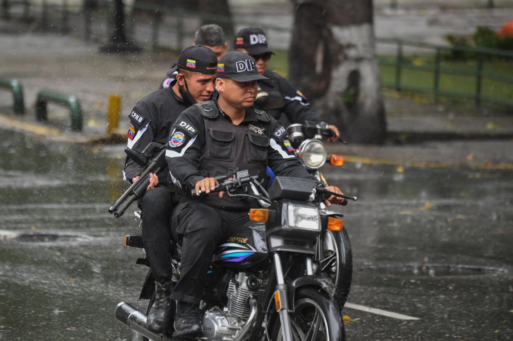 Members of the Directorate of Strategic Intelligence drive along one of the main streets of the Cota 905 neighbourhood in July 2021 after three days of clashes with alleged gang members in Caracas, Venezuela. Photo: TNS