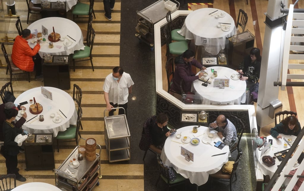 People in a Chinese restaurant. Most restaurants are limited to serving two diners per table, and none are allowed to serve dine-in customers after 6pm. Photo: Sam Tsang