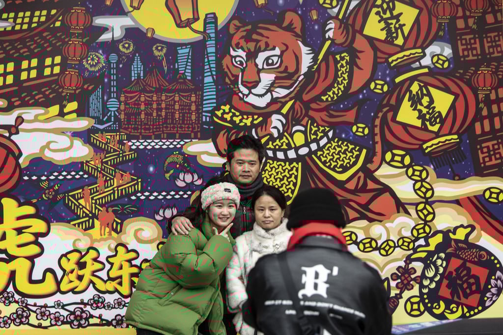 Visitors pose for photographs with festive decorations for Lunar New Year in Shanghai on February 2. President Xi Jinping’s concept of “common prosperity” hinges on building a sizeable middle class. Photo: Bloomberg Visitors pose for photographs with festive decorations for Lunar New Year in Shanghai on February 2. President Xi Jinping’s concept of “common prosperity” hinges on building a sizeable middle class. Photo: Bloomberg