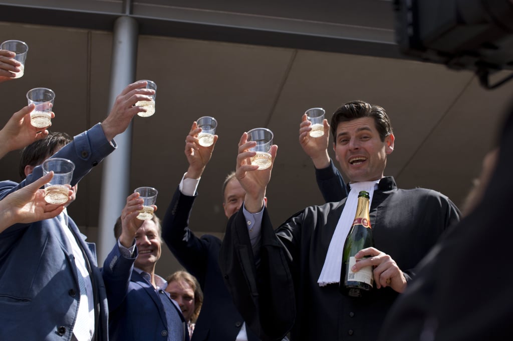 Dutch lawyer Roger Cox, right, toasts winning landmark climate cases. Photo: AP