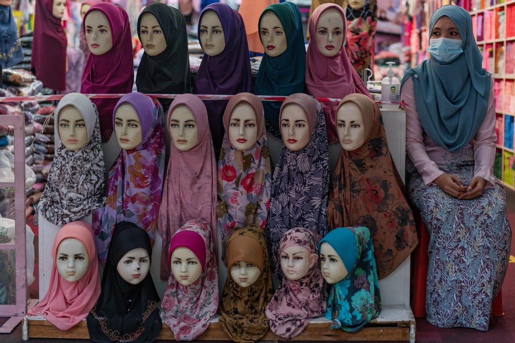 A vendor waits for customers at a shop selling assorted headscarves in Kuala Lumpur. File photo: AFP