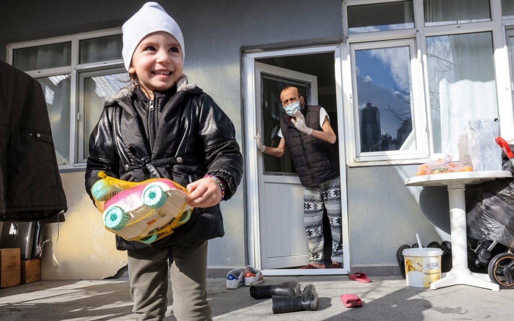 Muzaffer Kayasan is visited by his granddaughter Azra at his home’s backyard in Istanbul on Thursday. Photo: Reuters