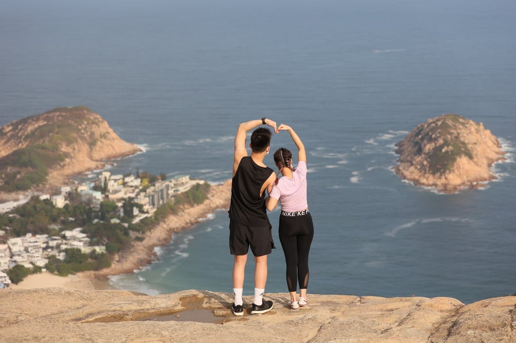 A couple hike on the Dragon’s Back with stunning views on Shek O below. Photo: Dickson Lee A couple hike on the Dragon’s Back with stunning views on Shek O below. Photo: Dickson Lee