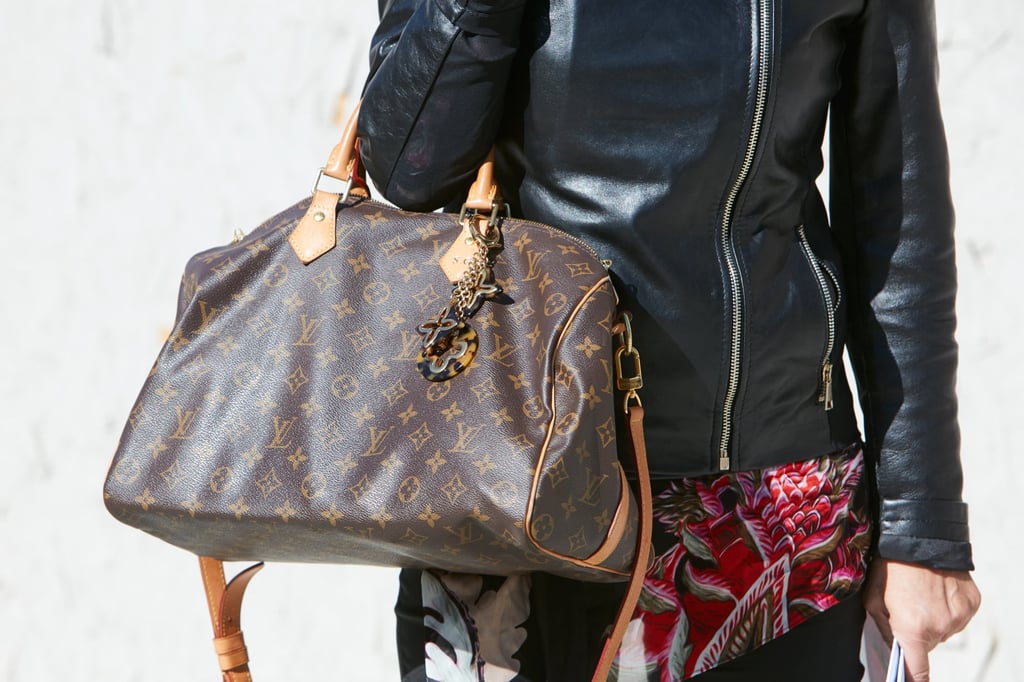 A woman with a Louis Vuitton handbag poses during Milan Fashion Week in 2017. Photo: Shutterstock A woman with a Louis Vuitton handbag poses during Milan Fashion Week in 2017. Photo: Shutterstock
