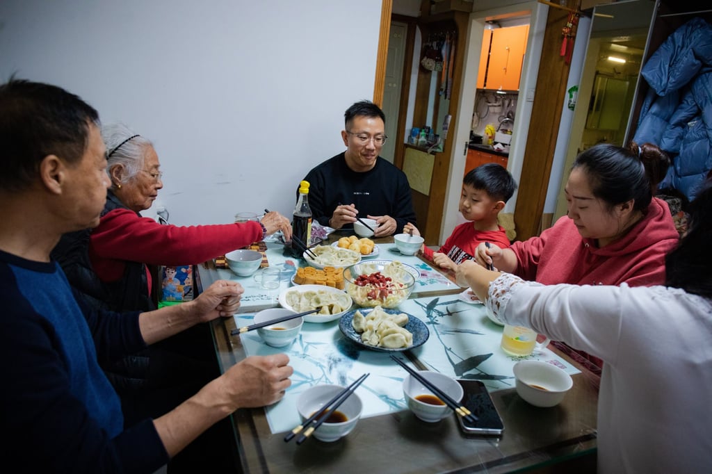 Family members gather together over traditional foods during Lunar New Year in Beijing, China. Photo: Varvara Kotsebuk/Anadolu Agency via Getty Images