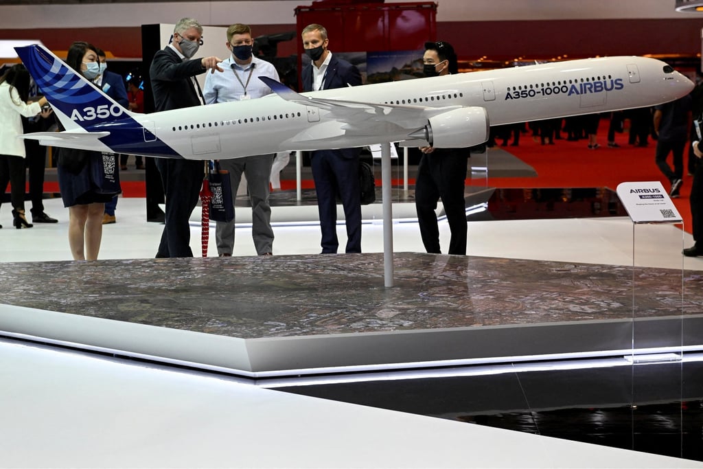 Visitors look at a model of a passenger jet in the Airbus pavilion at Singapore Airshow on Wednesday. Photo: Reuters
