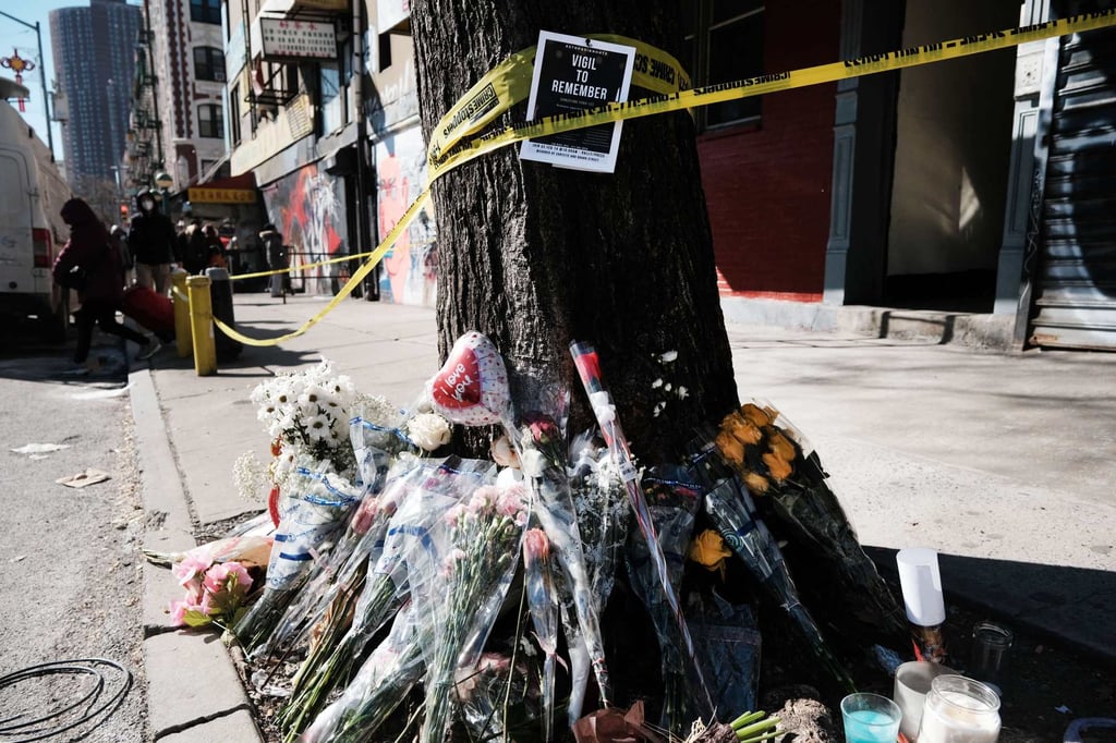 Flowers outside the building where Christina Yuna Lee was murdered Photo: AFP