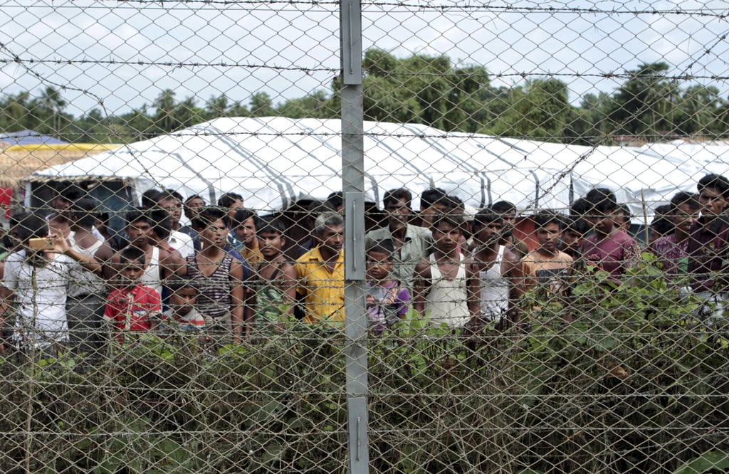Rohingya refugees gather near a fence near Taungpyolatyar village, Maung Daw, northern Rakhine State. File photo: AP