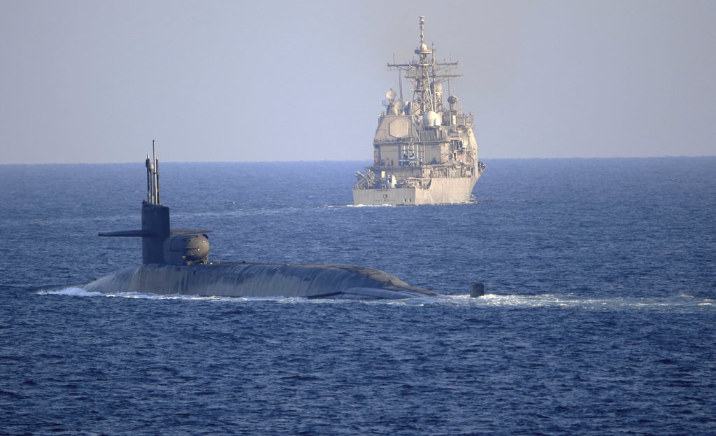 The guided-missile submarine USS Georgia, front, transits the Strait of Hormuz with the guided-missile cruiser USS Port Royal in 2020. File photo: TNS