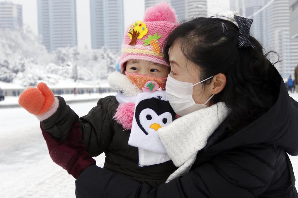 A North Korean woman and child seen at Lunar New Year celebrations in Pyongyang earlier this month. Photo: AP A North Korean woman and child seen at Lunar New Year celebrations in Pyongyang earlier this month. Photo: AP