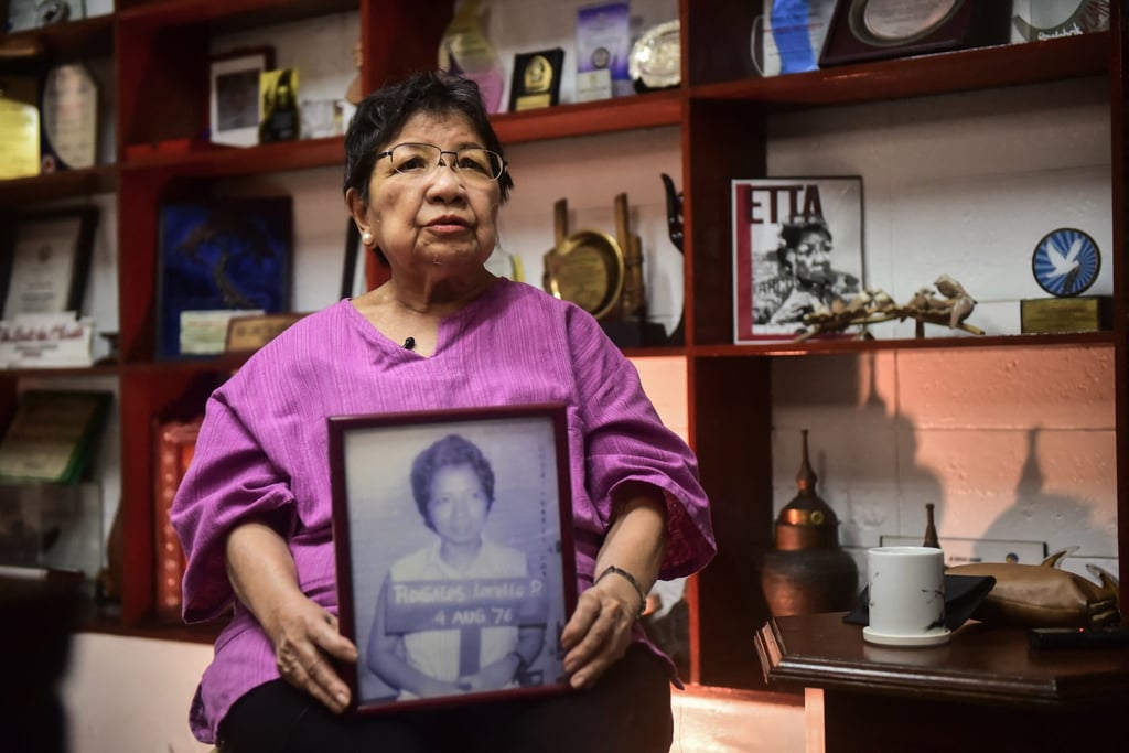 Loretta Rosales shows a photo from when she was arrested after martial law was declared. Photo: Maria Tan