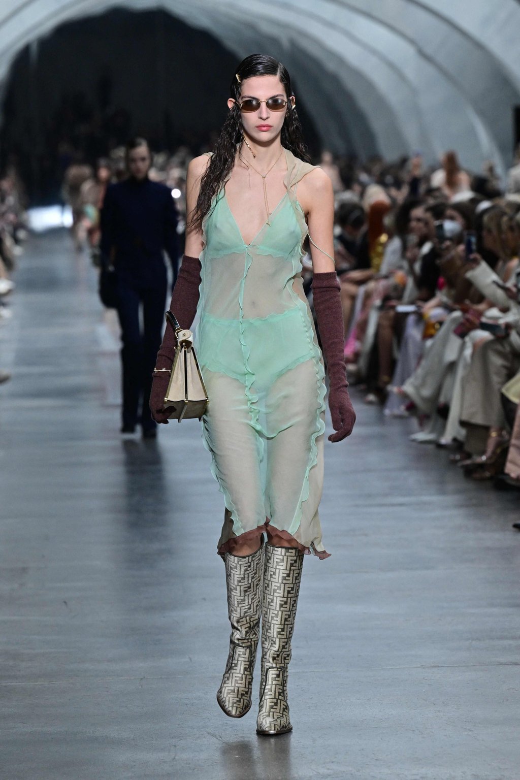 A model dons a sheer dress paired with boots featuring Fendi’s distinctive logo motif for the brand’s women’s autumn/winter 2022-2023 show on the second day of the Milan Fashion Week in Milan, on February 23. Photo: AFP