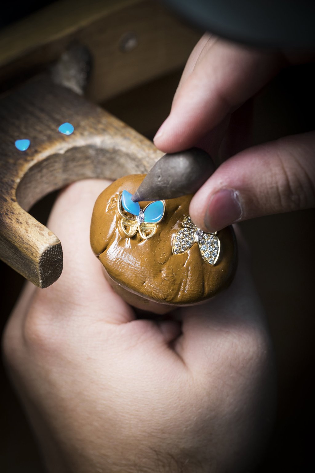 Positioning the turquoise on a Two Butterfly collection piece.