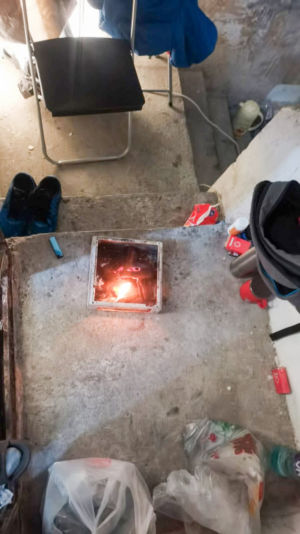 A construction worker surnamed Chan burned charcoal for heat while he and his wife slept on the rooftop of their tenement building after testing positive for Covid-19. Photo: Handout A construction worker surnamed Chan burned charcoal for heat while he and his wife slept on the rooftop of their tenement building after testing positive for Covid-19. Photo: Handout