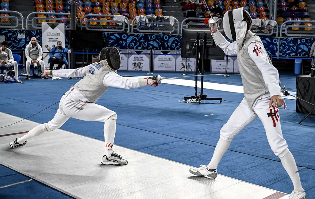 Hong Kong team foil fencer Lawrence Ng Lok-wang (right) against Alexander Kahl, of Germany, in the FIE World Cup round of 128 event in Egypt. Photo: FIE Hong Kong team foil fencer Lawrence Ng Lok-wang (right) against Alexander Kahl, of Germany, in the FIE World Cup round of 128 event in Egypt. Photo: FIE