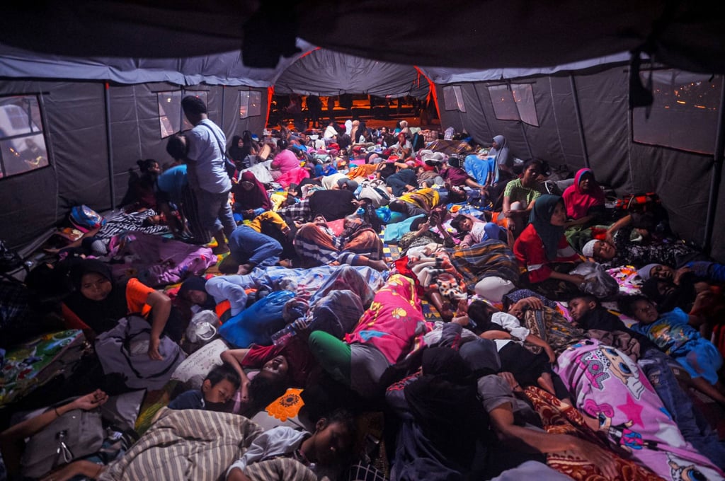 People gather in a tent in West Pasaman, Indonesia’s West Sumatra province on February 26, 2022, a day after a magnitude 6.2 earthquake struck the region. Photo: Agence France-Presse