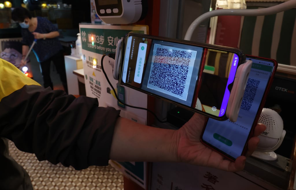 Mobile phones set up at Kam Kee Cafe in Causeway Bay to scan vaccination records. Photo: May Tse