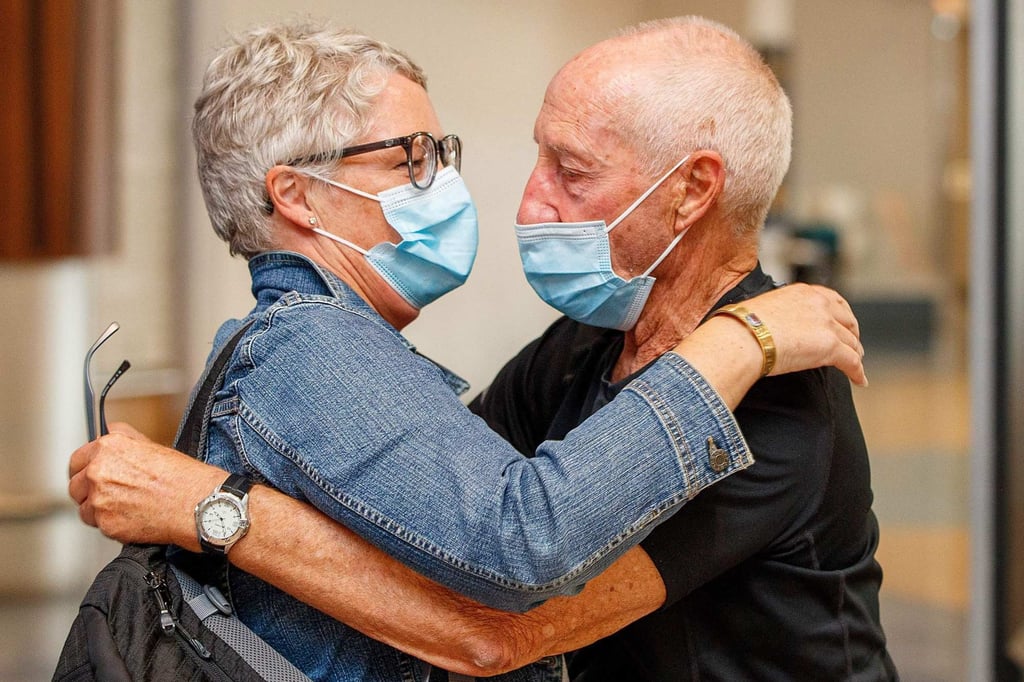 Passengers and loved ones reunite at Auckland airport on Monday. Photo: AFP Passengers and loved ones reunite at Auckland airport on Monday. Photo: AFP