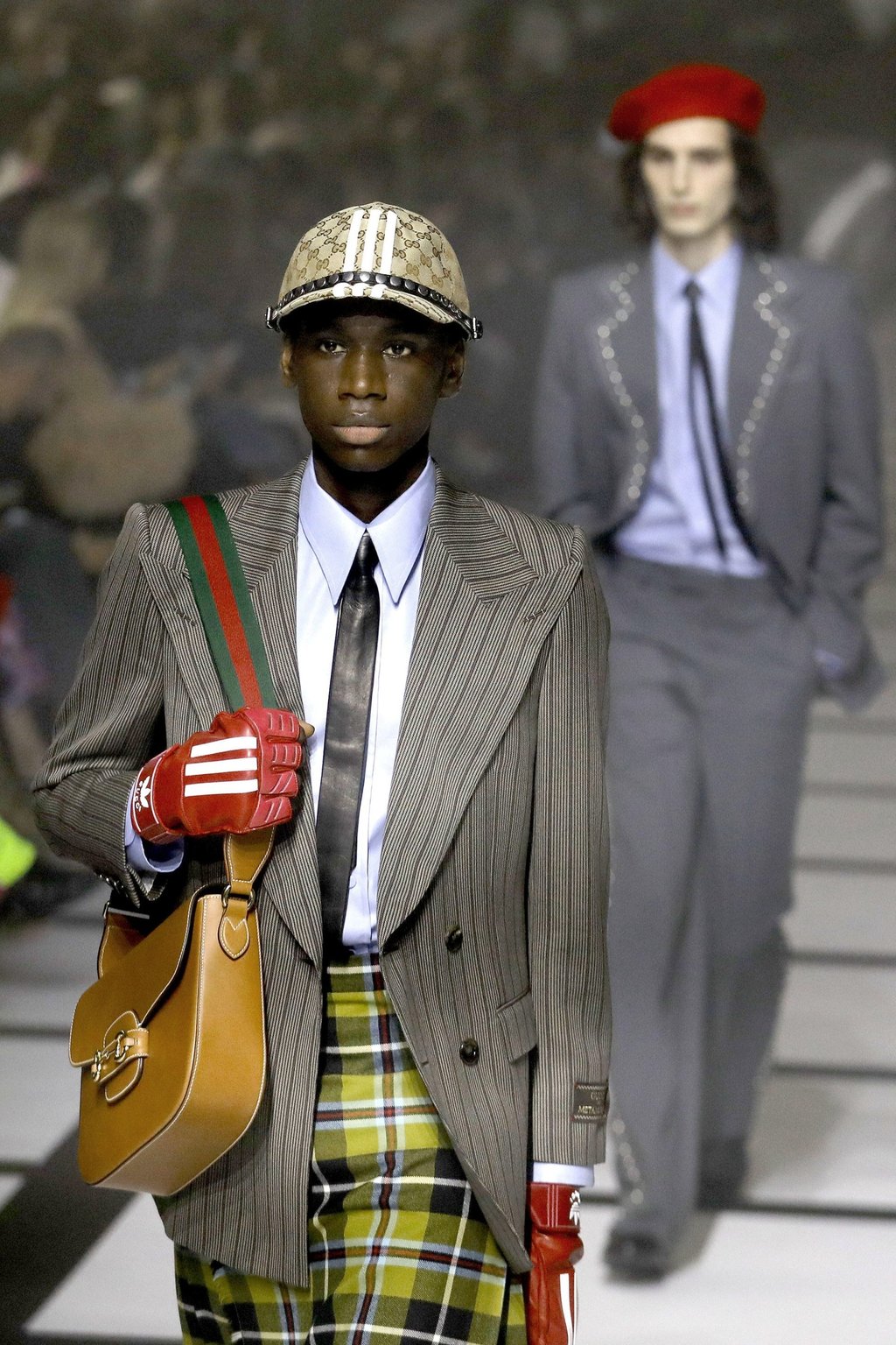 It finally happened Gucci and Adidas collaboration at Milan Fashion Week 2022 featured athletic style dresses and suits with Rihanna A AP Rocky and Stan Smith gracing the front row South China