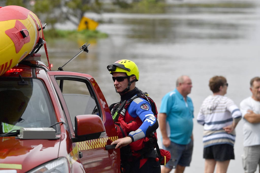 A State Emergency Services (SES) volunteer unloads a boat to visit the a flood affected area in New South Wales on March 1, 2022. Photo: AFP A State Emergency Services (SES) volunteer unloads a boat to visit the a flood affected area in New South Wales on March 1, 2022. Photo: AFP