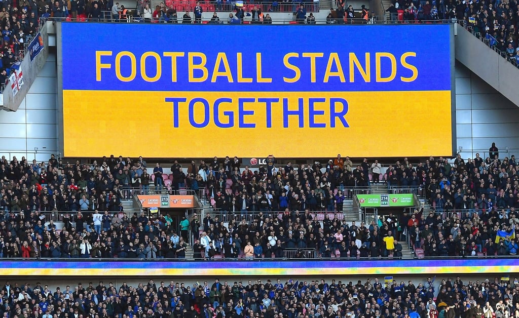 The slogan ‘Football stands together’ displayed on a huge screen before the English Carabao Cup final between Chelsea and Liverpool on Sunday. Photo: EPA-EFE