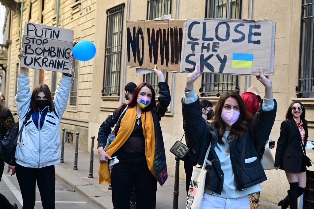 Women holding banners protesting the Russian invasion of Ukraine are pictured outside the Giorgio Armani catwalk show at Milan Fashion Week. Photo: AFP Women holding banners protesting the Russian invasion of Ukraine are pictured outside the Giorgio Armani catwalk show at Milan Fashion Week. Photo: AFP